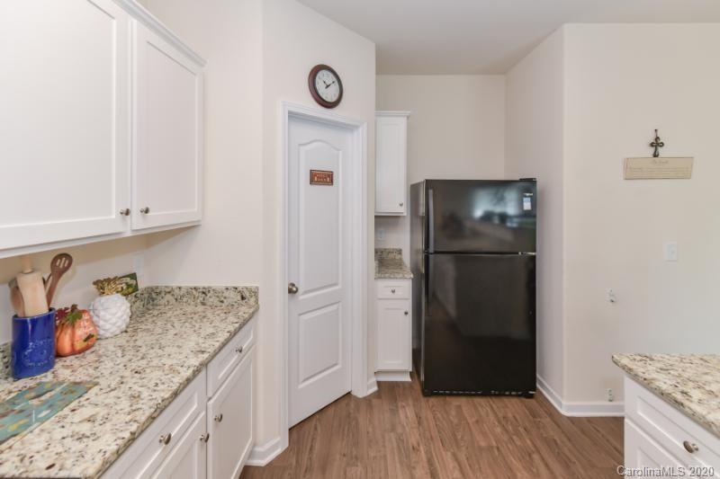 6565 Paw Village Road Charlotte, NC 28214 - Photo 5 of 26 a kitchen with granite countertop a refrigerator and a sink