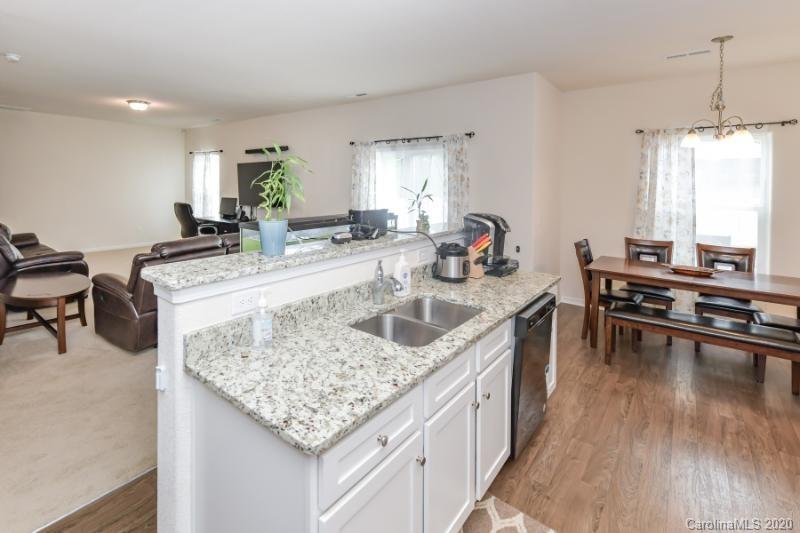 6565 Paw Village Road Charlotte, NC 28214 - Photo 6 of 26 a kitchen with granite countertop a sink and a stove