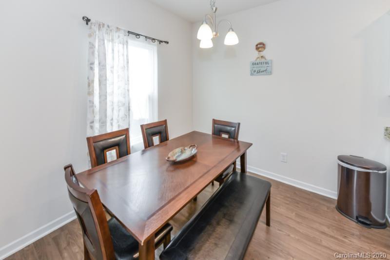 6565 Paw Village Road Charlotte, NC 28214 - Photo 9 of 26 a view of a dining room with furniture and wooden floor