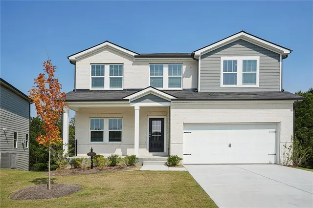a front view of a house with a yard