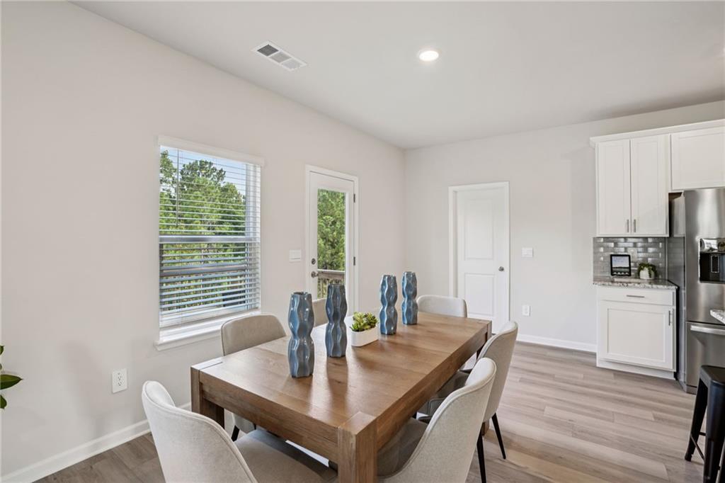 202 Proust Circle Dallas, GA 30132 - Photo 11 of 47 a view of a dining room with furniture window and wooden floor