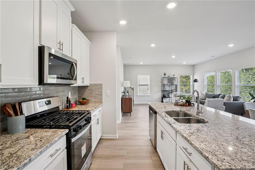 202 Proust Circle Dallas, GA 30132 - Photo 13 of 47 a kitchen with stainless steel appliances granite countertop a sink stove and refrigerator