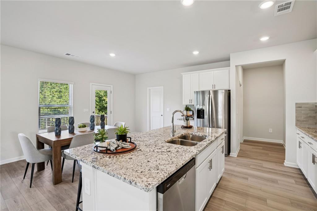 202 Proust Circle Dallas, GA 30132 - Photo 15 of 47 a kitchen with center island and stainless steel appliances