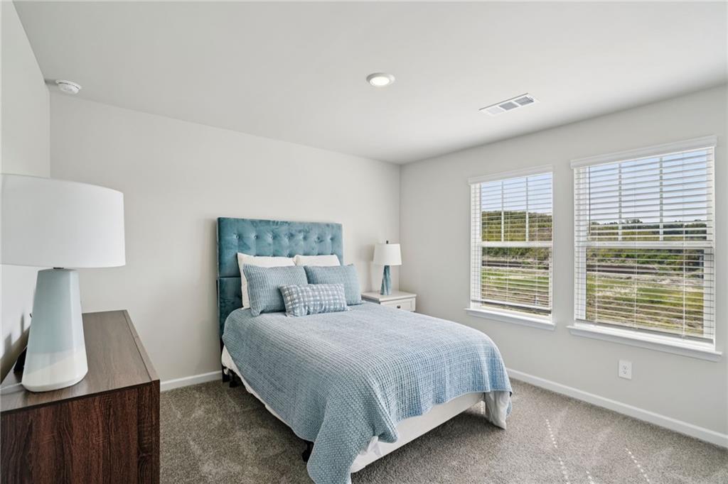 202 Proust Circle Dallas, GA 30132 - Photo 27 of 47 a bedroom with a bed and a window