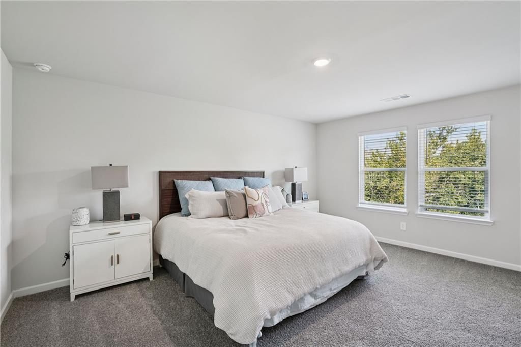 202 Proust Circle Dallas, GA 30132 - Photo 29 of 47 a bedroom with a bed and a large window