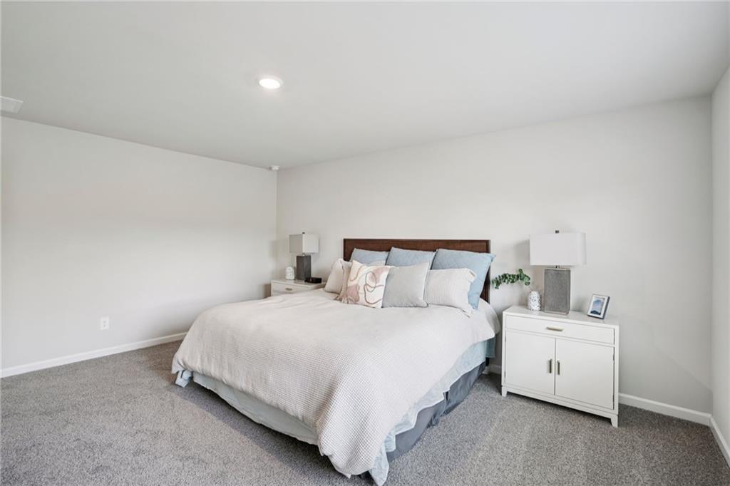 202 Proust Circle Dallas, GA 30132 - Photo 30 of 47 a bedroom with a bed and a night stand