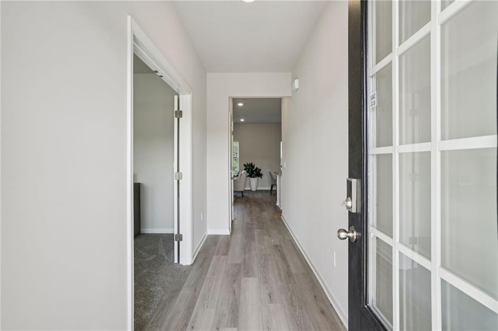 202 Proust Circle Dallas, GA 30132 - Photo 3 of 47 a view of a hallway with wooden floor and staircase