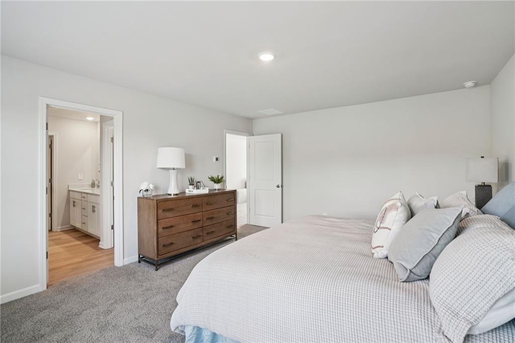 202 Proust Circle Dallas, GA 30132 - Photo 31 of 47 a bedroom with a bed and a dresser