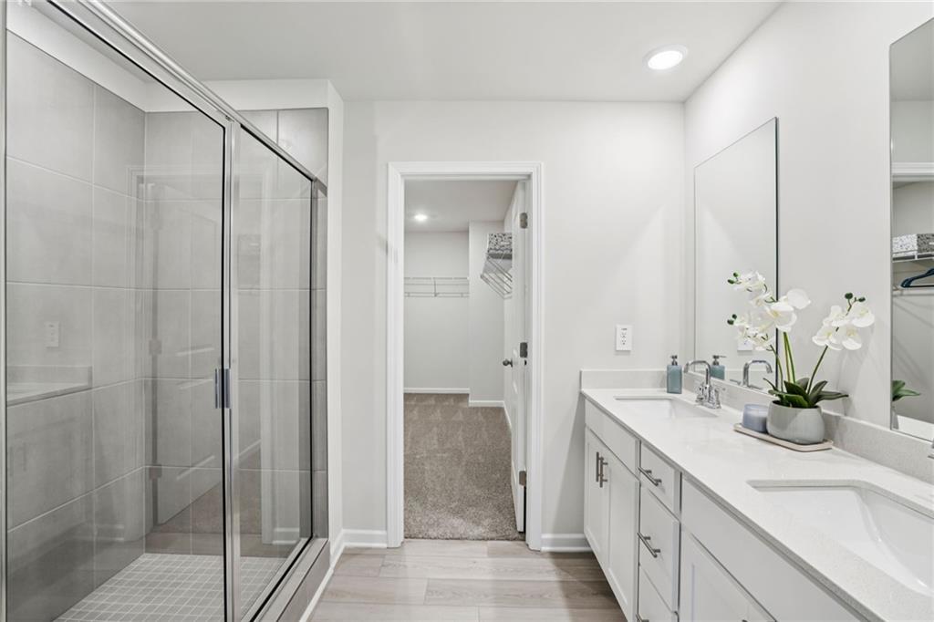 202 Proust Circle Dallas, GA 30132 - Photo 32 of 47 a bathroom with a double vanity sink and shower