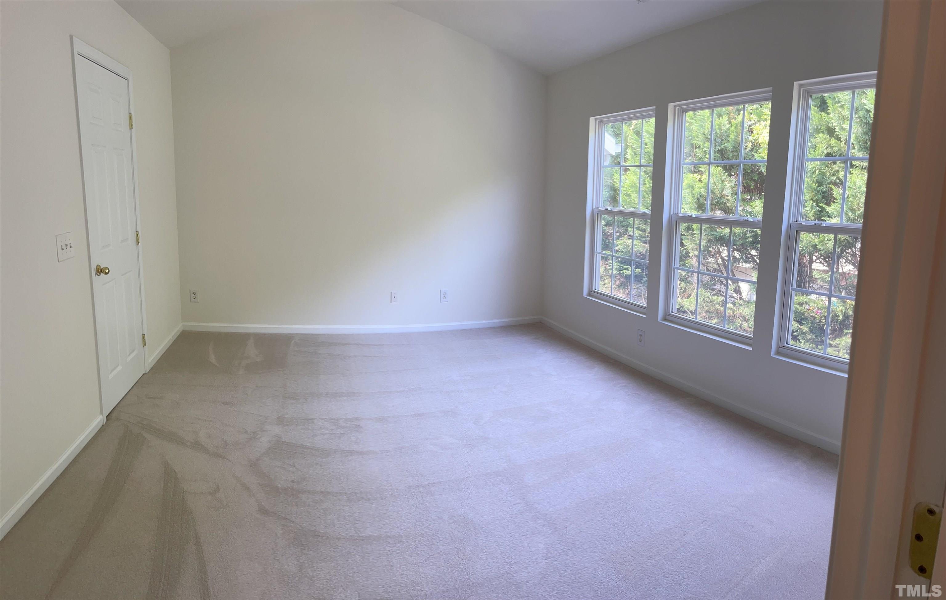 8521 Bright Loop Raleigh, NC 27613 - Photo 11 of 20 a view of an empty room with a window