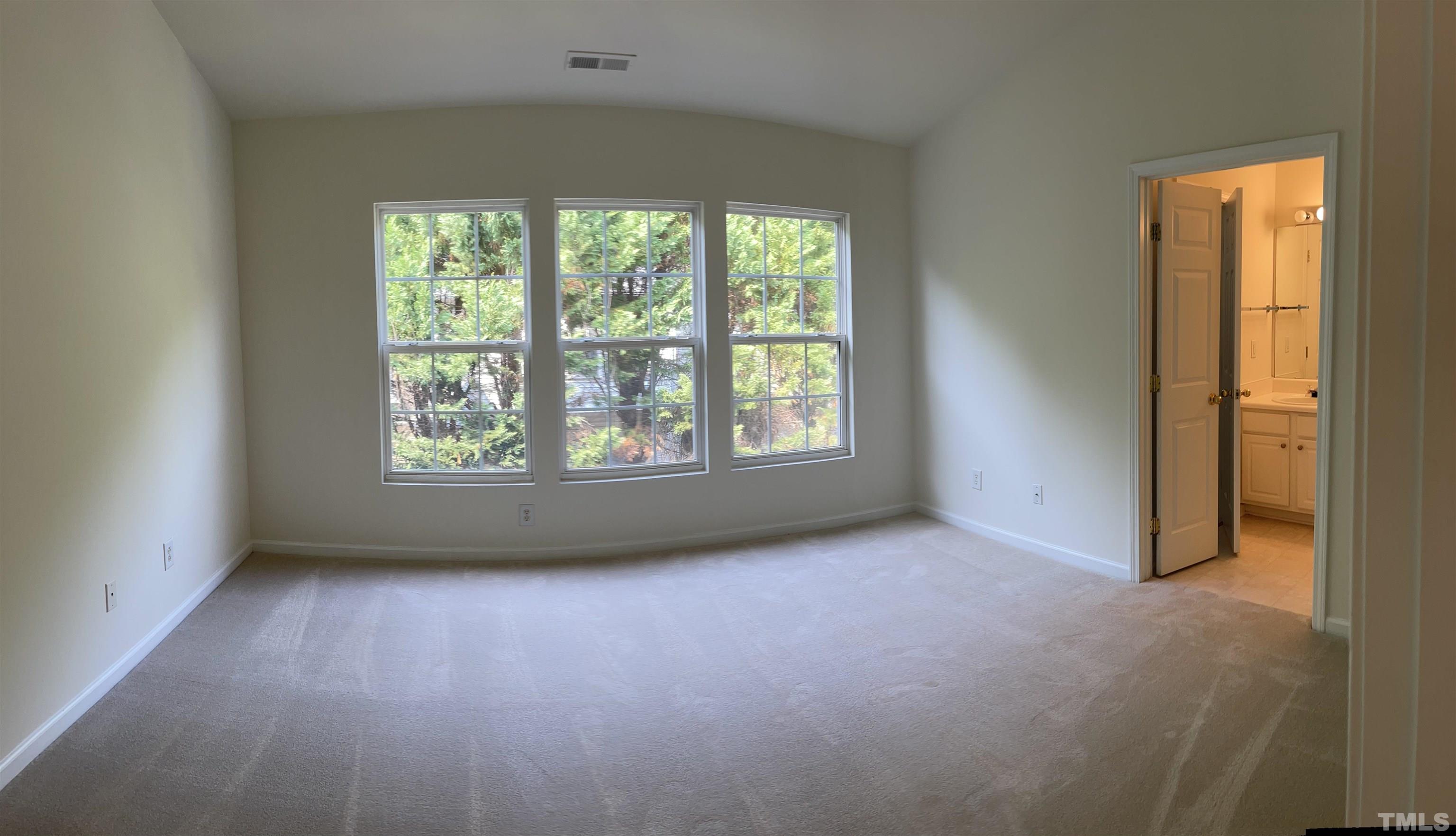 8521 Bright Loop Raleigh, NC 27613 - Photo 12 of 20 an empty room with windows and closet