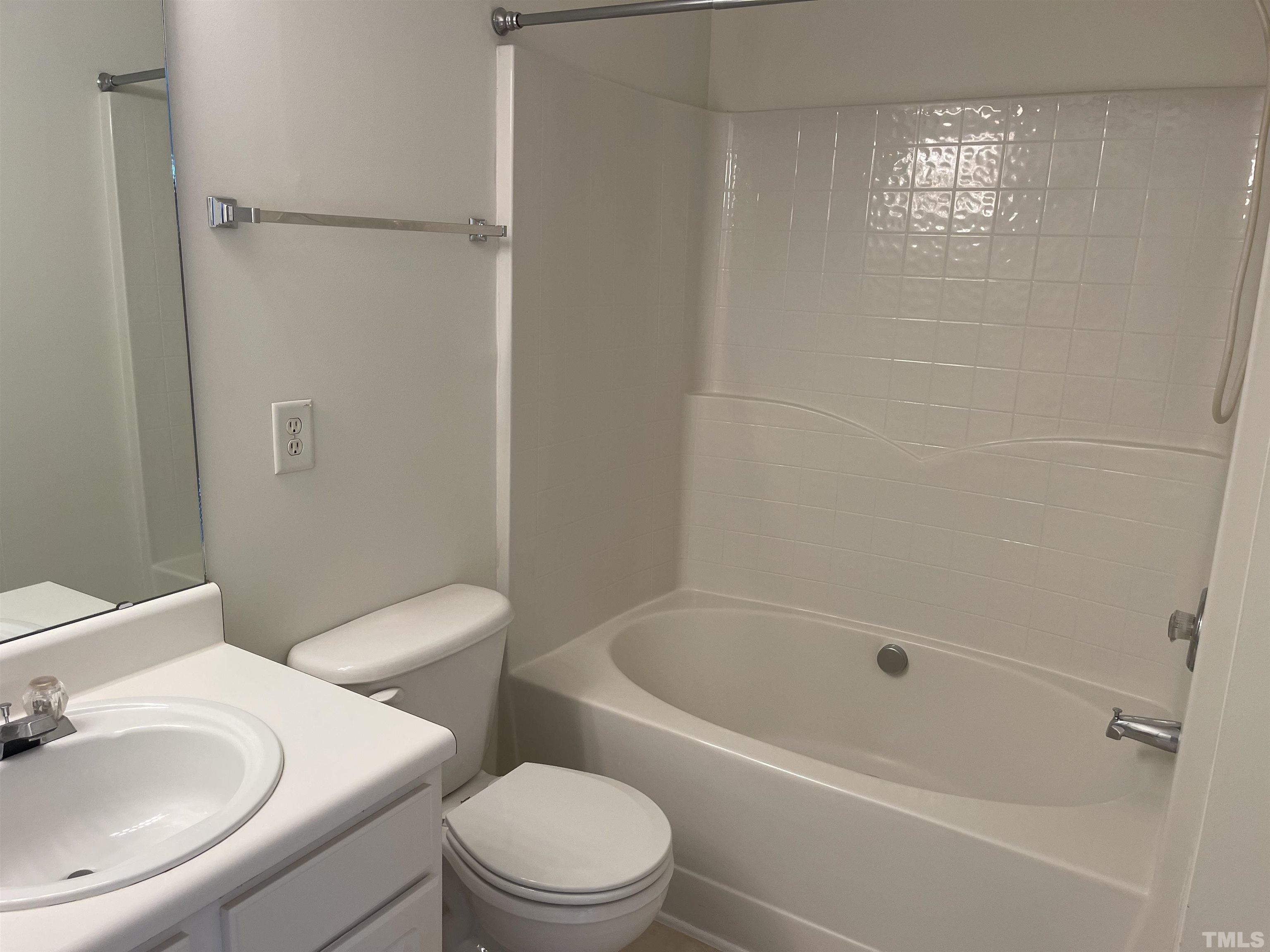 8521 Bright Loop Raleigh, NC 27613 - Photo 15 of 20 a white toilet sitting next to a bath tub