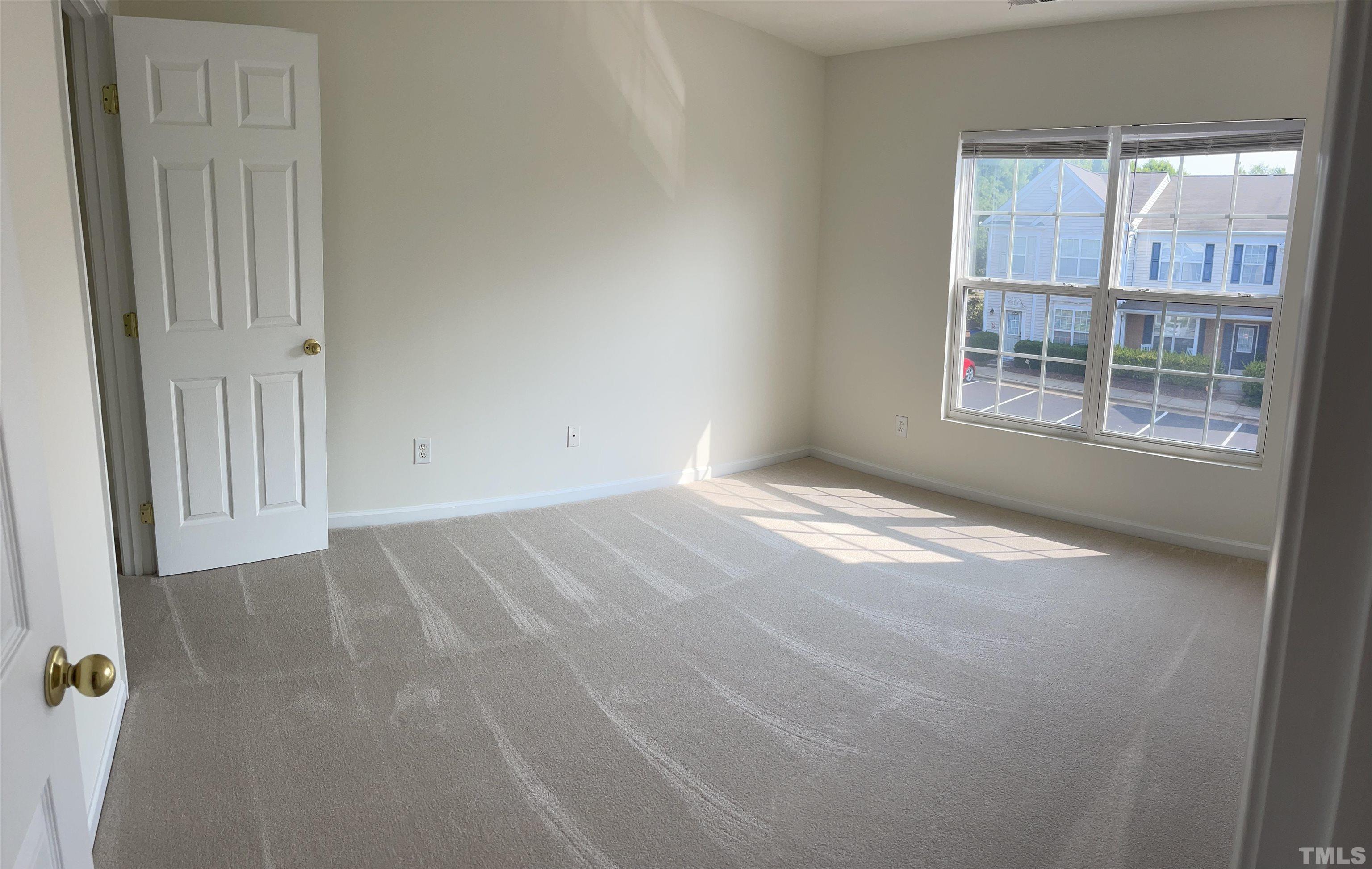 8521 Bright Loop Raleigh, NC 27613 - Photo 16 of 20 an empty room with windows