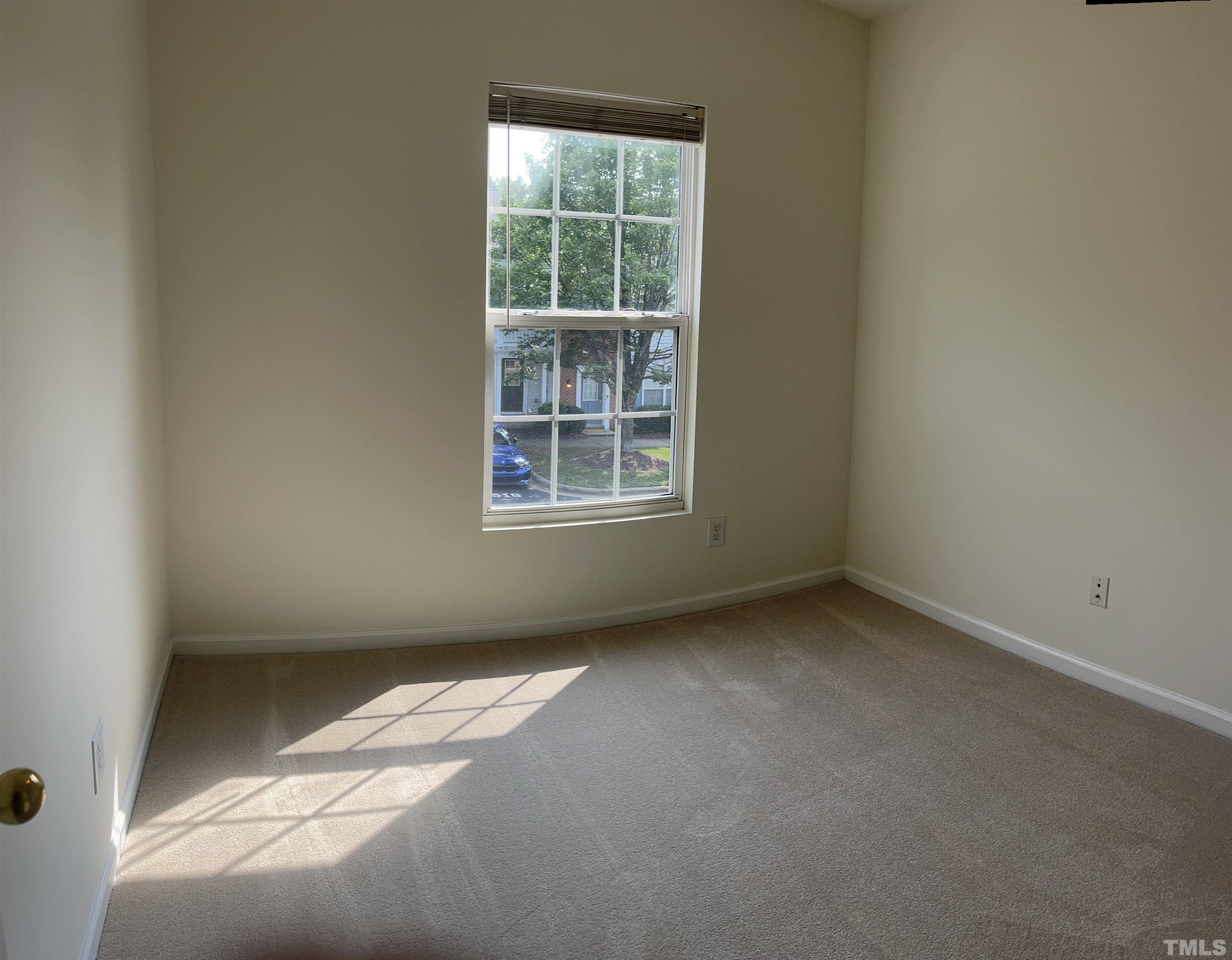 8521 Bright Loop Raleigh, NC 27613 - Photo 19 of 20 an empty room with a window