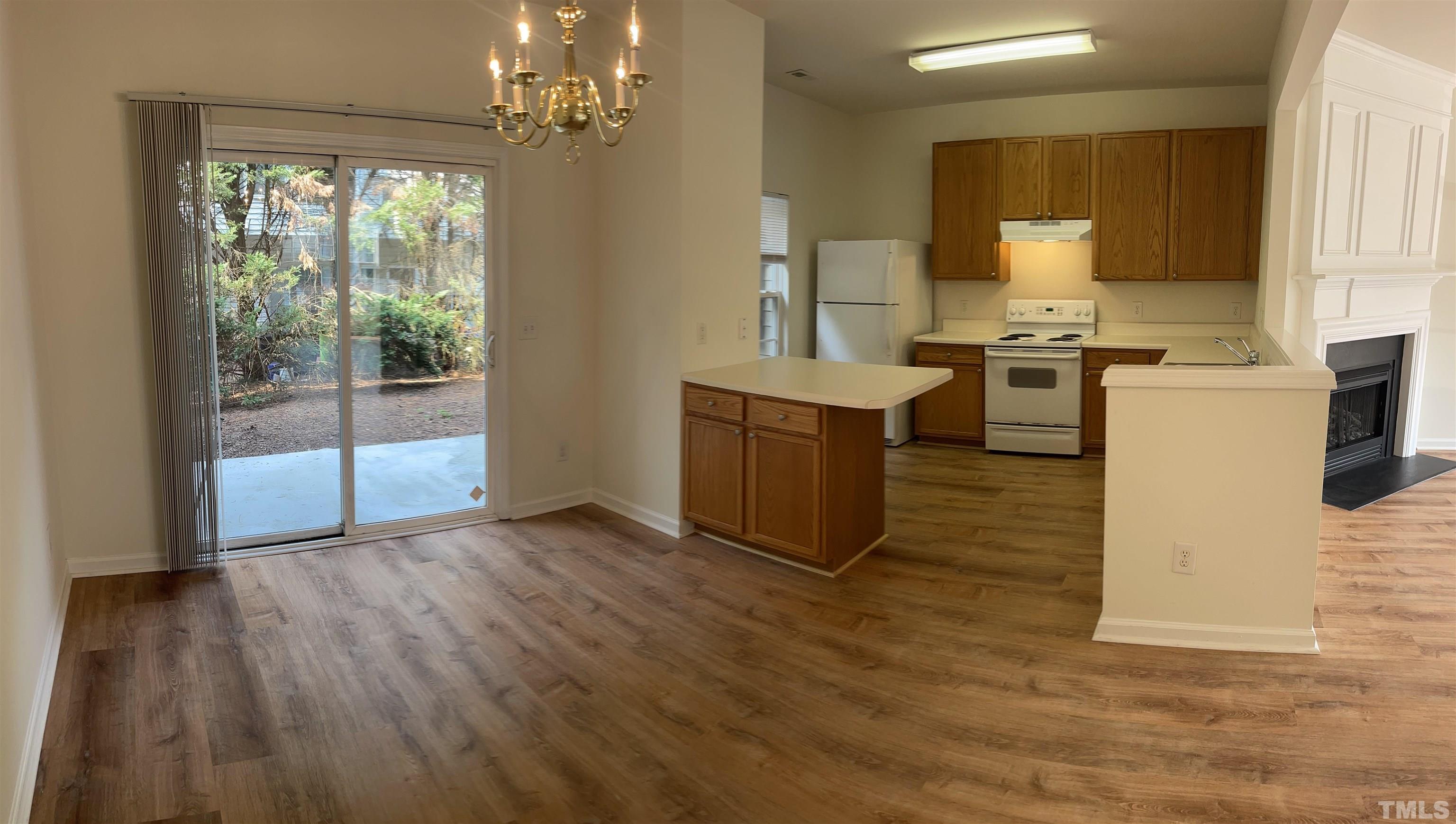 8521 Bright Loop Raleigh, NC 27613 - Photo 3 of 20 a view of kitchen with granite countertop cabinets and outdoor space