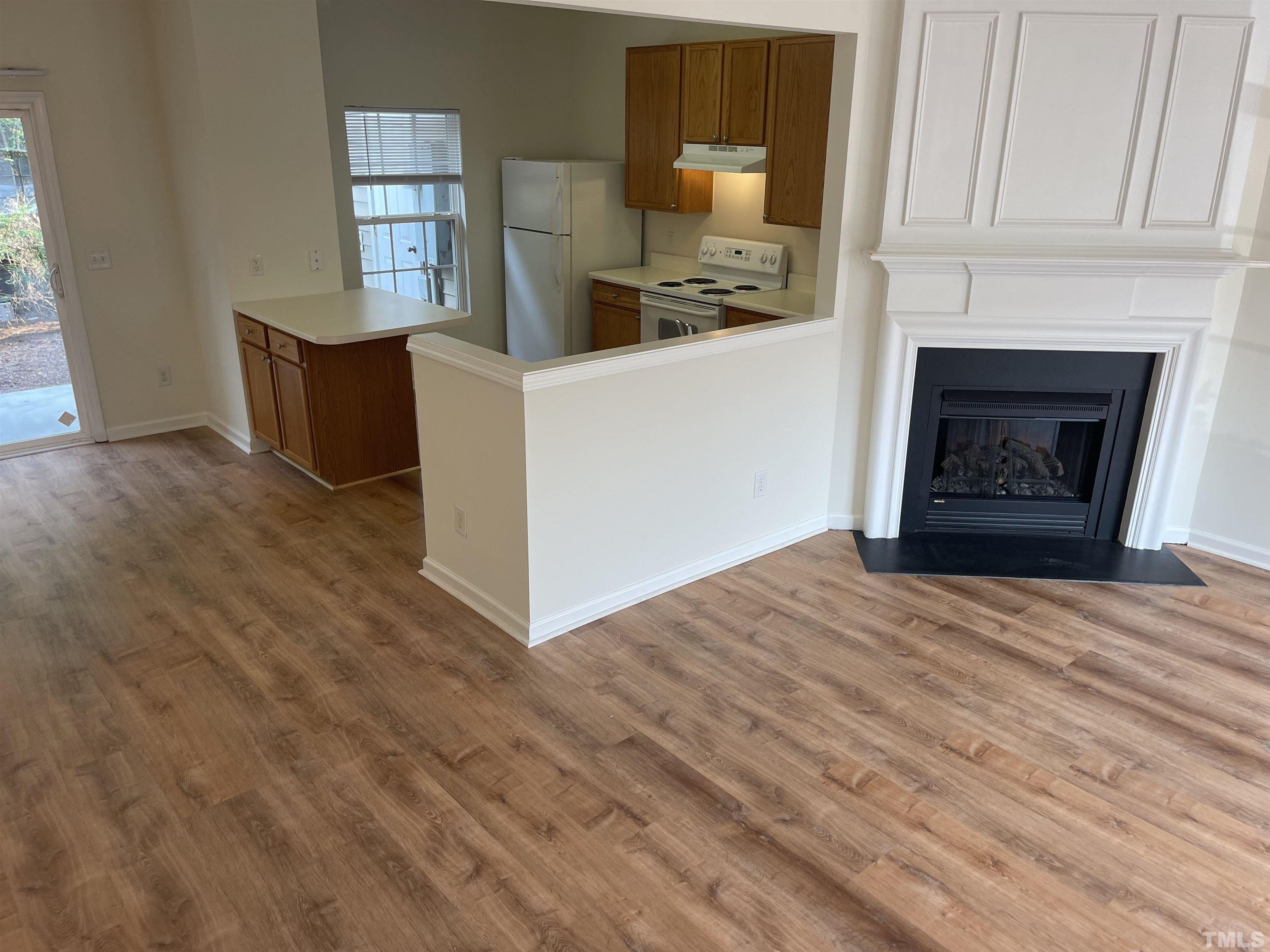8521 Bright Loop Raleigh, NC 27613 - Photo 5 of 20 a view of a kitchen with furniture and a fireplace