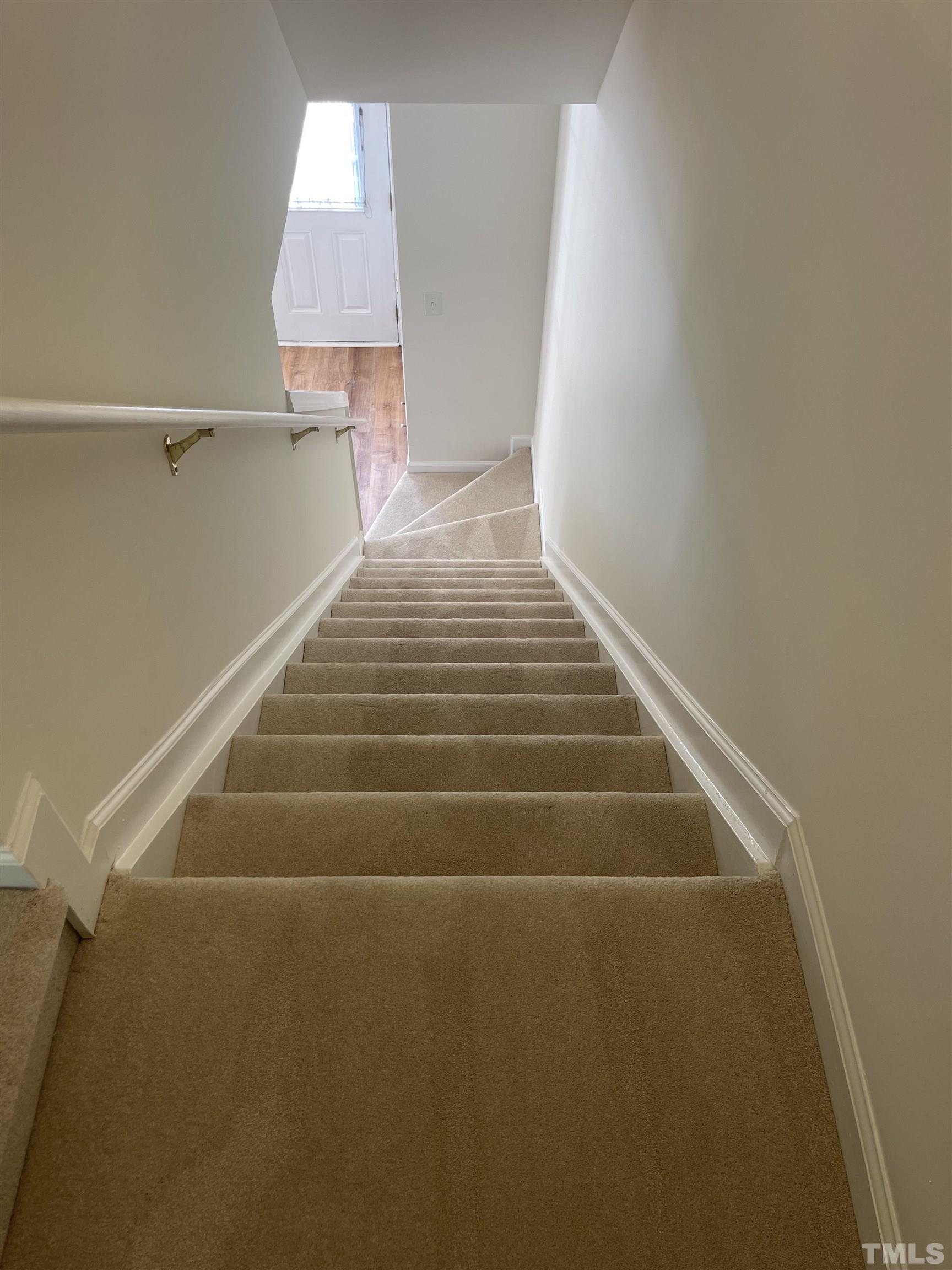 8521 Bright Loop Raleigh, NC 27613 - Photo 9 of 20 a view of entryway and hall with wooden floor