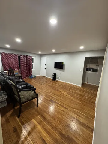 a view of a room with furniture and wooden floor