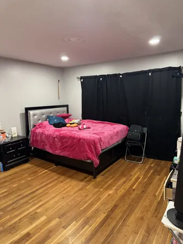 a bedroom with a bed and a mirror