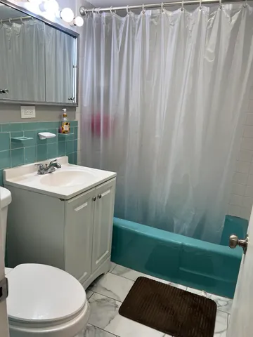a bathroom with a sink a toilet and vanity