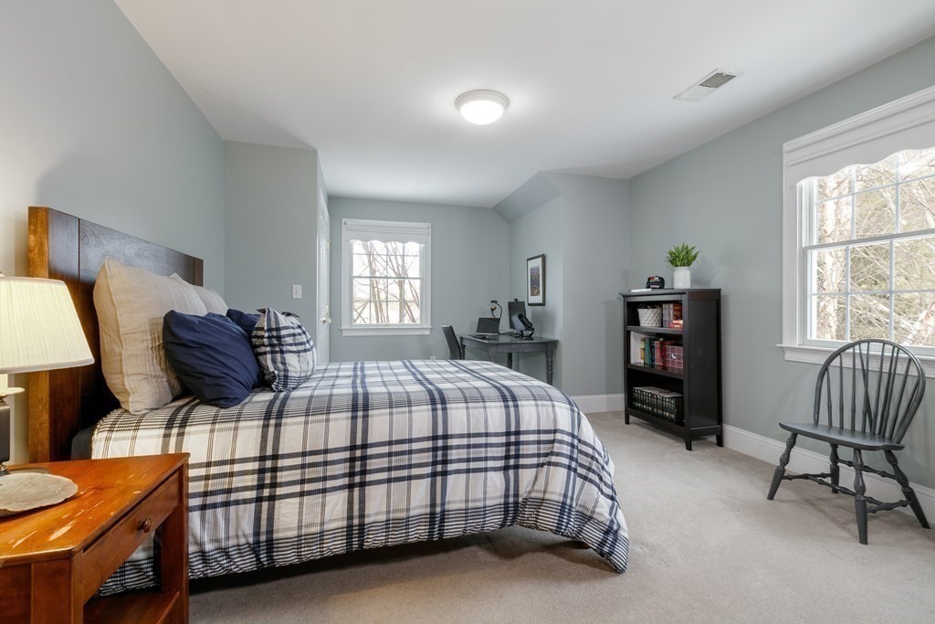 29 Old Bridge Road Concord, MA 01742 - Photo 25 of 37 a bedroom with a bed and a chair