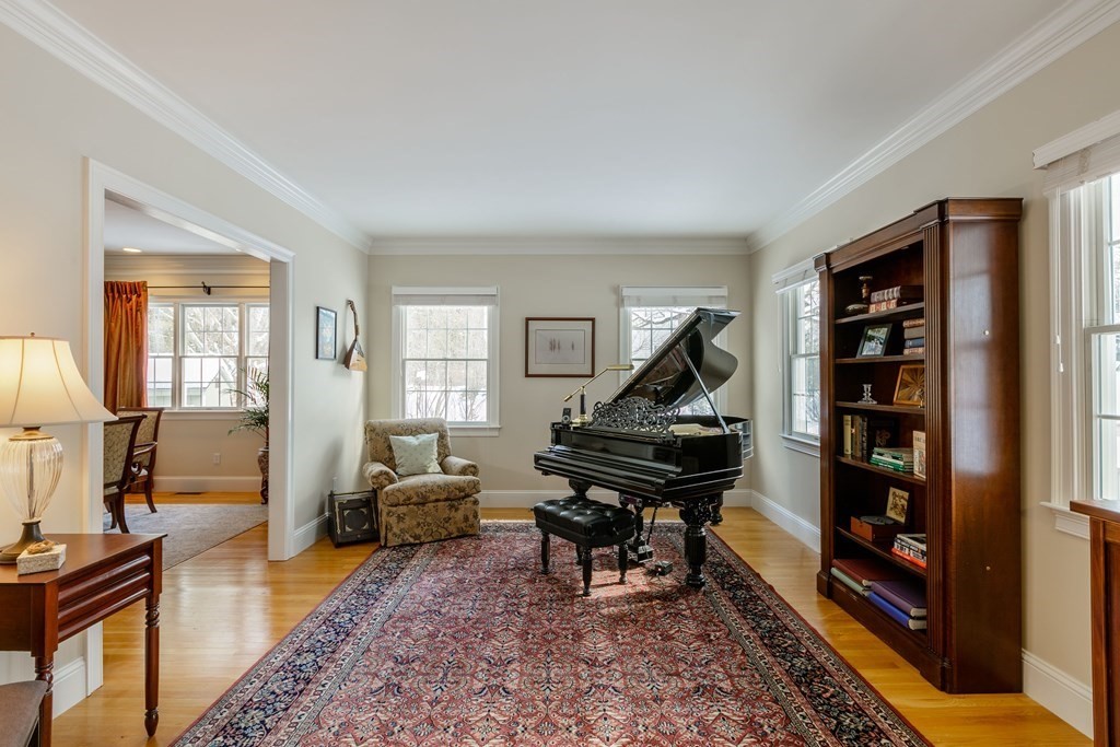 29 Old Bridge Road Concord, MA 01742 - Photo 4 of 37 a living room with furniture a piano and a bookshelf