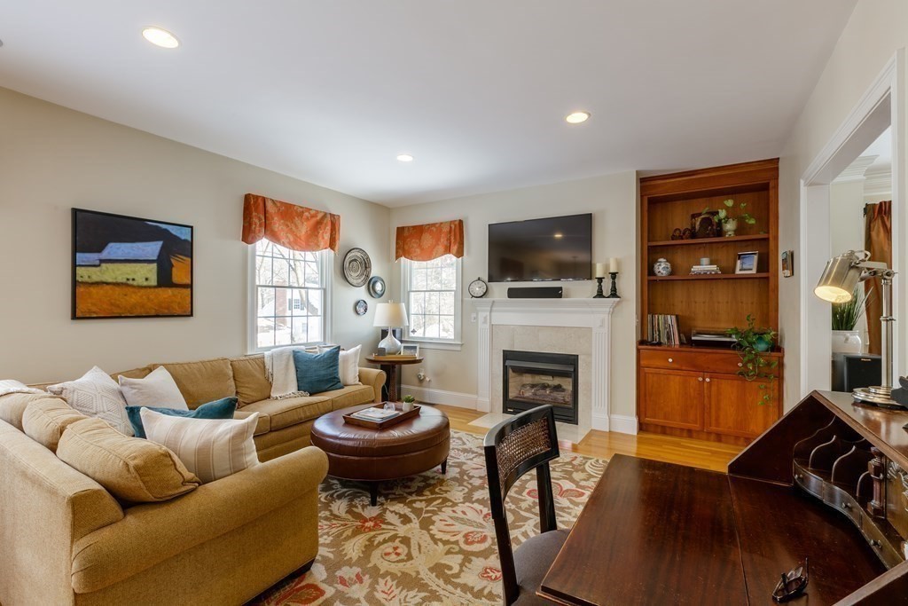 29 Old Bridge Road Concord, MA 01742 - Photo 8 of 37 a living room with furniture a fireplace and a flat screen tv