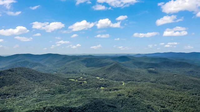 a view of a big yard with mountain view
