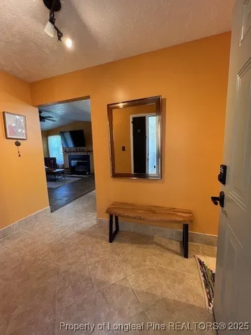 a view of a livingroom with furniture and a ceiling fan