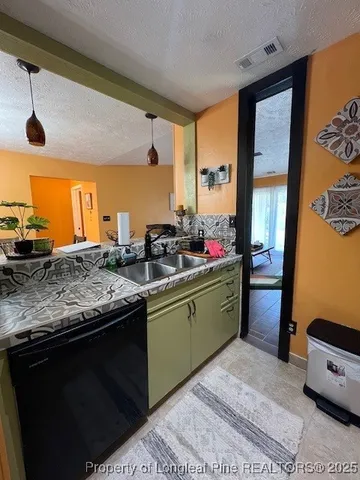 a kitchen with stainless steel appliances granite countertop sink stove and refrigerator