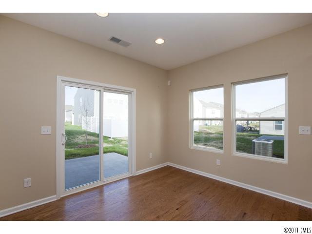 2183 Durand Road, Unit 84 Fort Mill, SC 29715 - Photo 8 of 16 a view of an empty room with wooden floor and windows