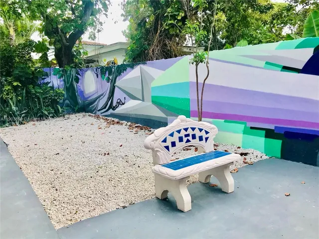 a roof deck with table and chairs potted plants