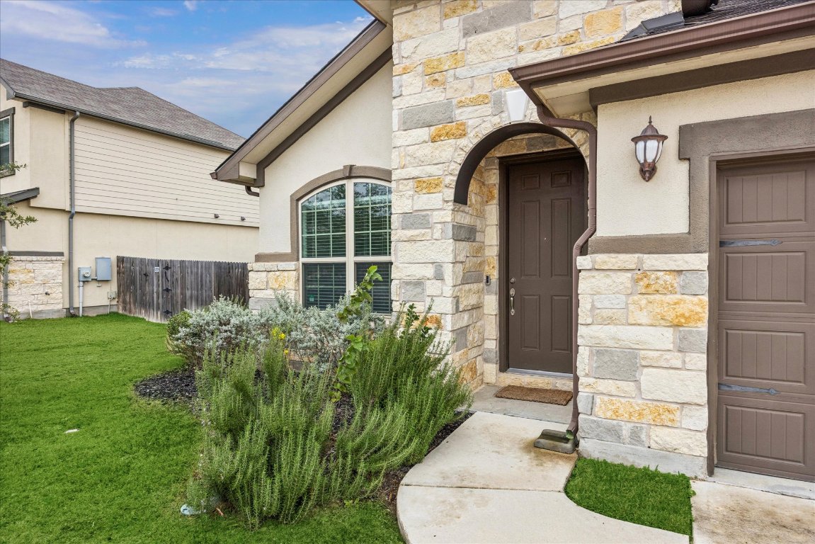 19201 Quebrada Drive Pflugerville, TX 78660 - Photo 2 of 22 a house view with a garden space