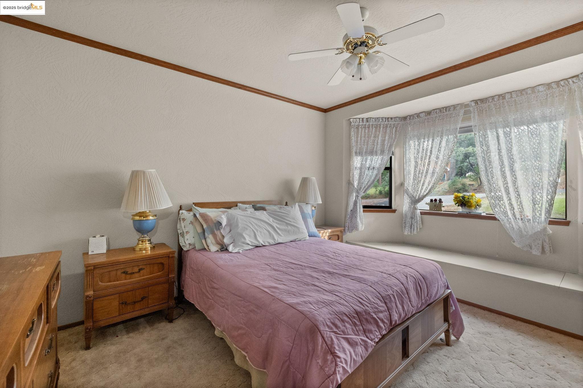 12087 Breckenridge Road Groveland, CA 95321 - Photo 16 of 31 Bedroom with light carpet, ceiling fan, and crown molding
