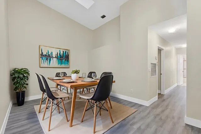 a view of an empty room with wooden floor