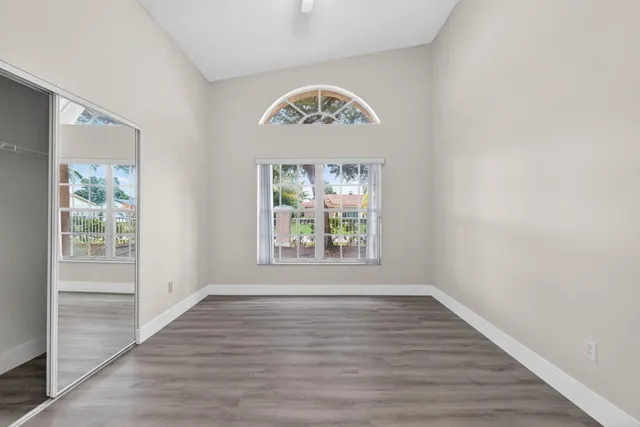 a bedroom with a large bed and a window