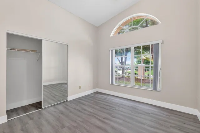 a bedroom with a balcony a bed and a flat screen tv