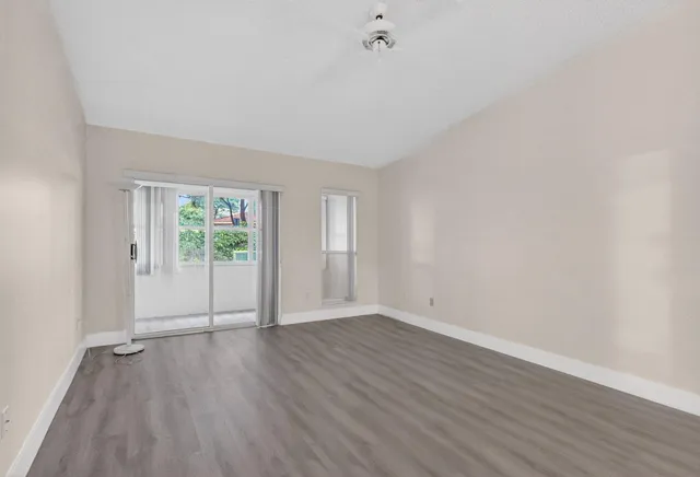 a view of a city from a big room with wooden floor windows