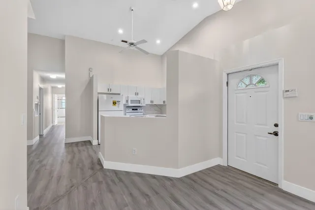 a view of a dining room with furniture and wooden floor