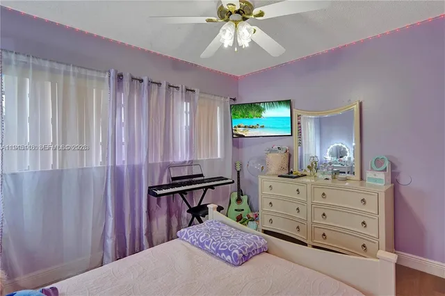 a bedroom with a bed and a dresser in it