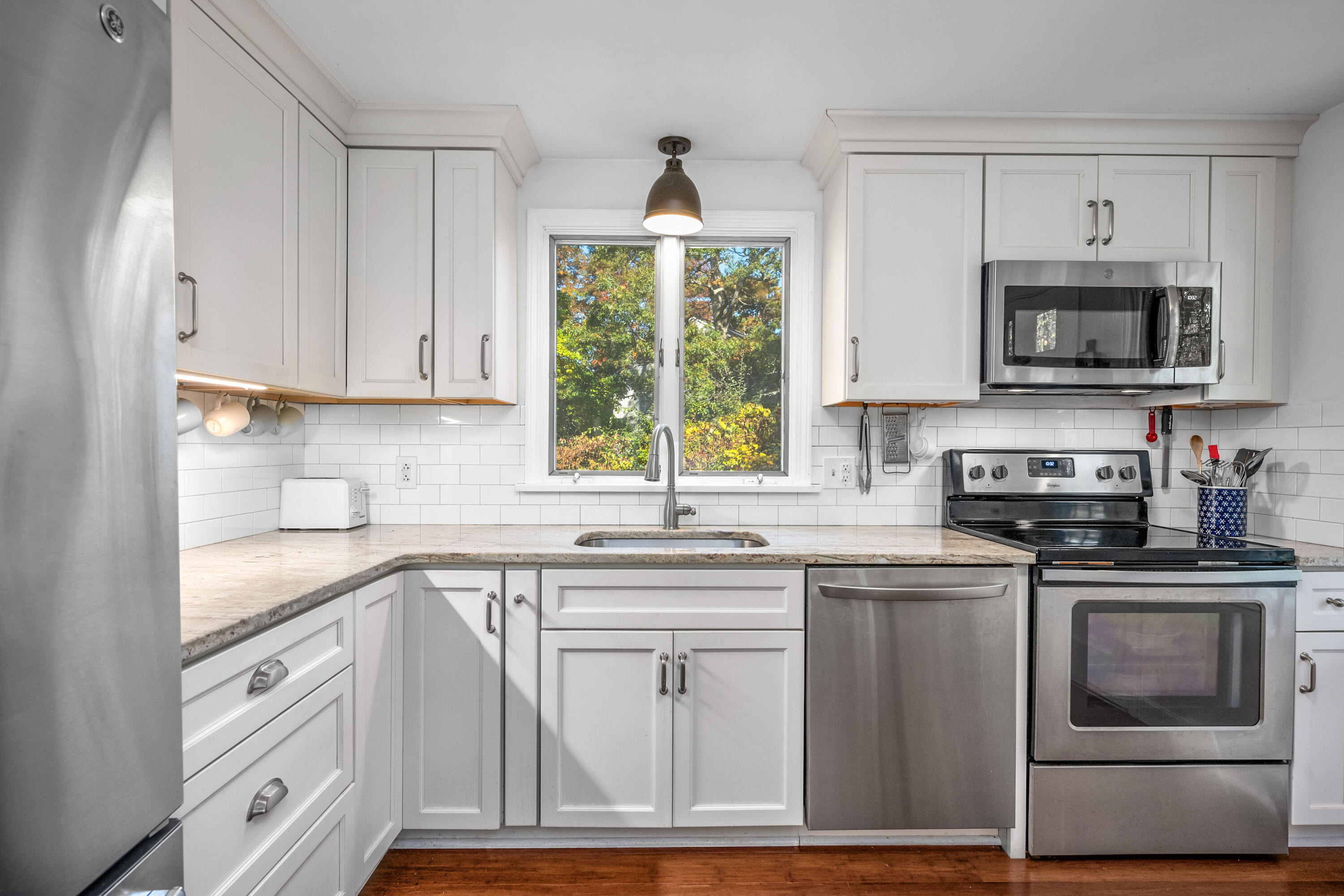 43 Chipman Road Sandwich, MA 02563 - Photo 14 of 35 a kitchen with cabinets stainless steel appliances a sink and a window