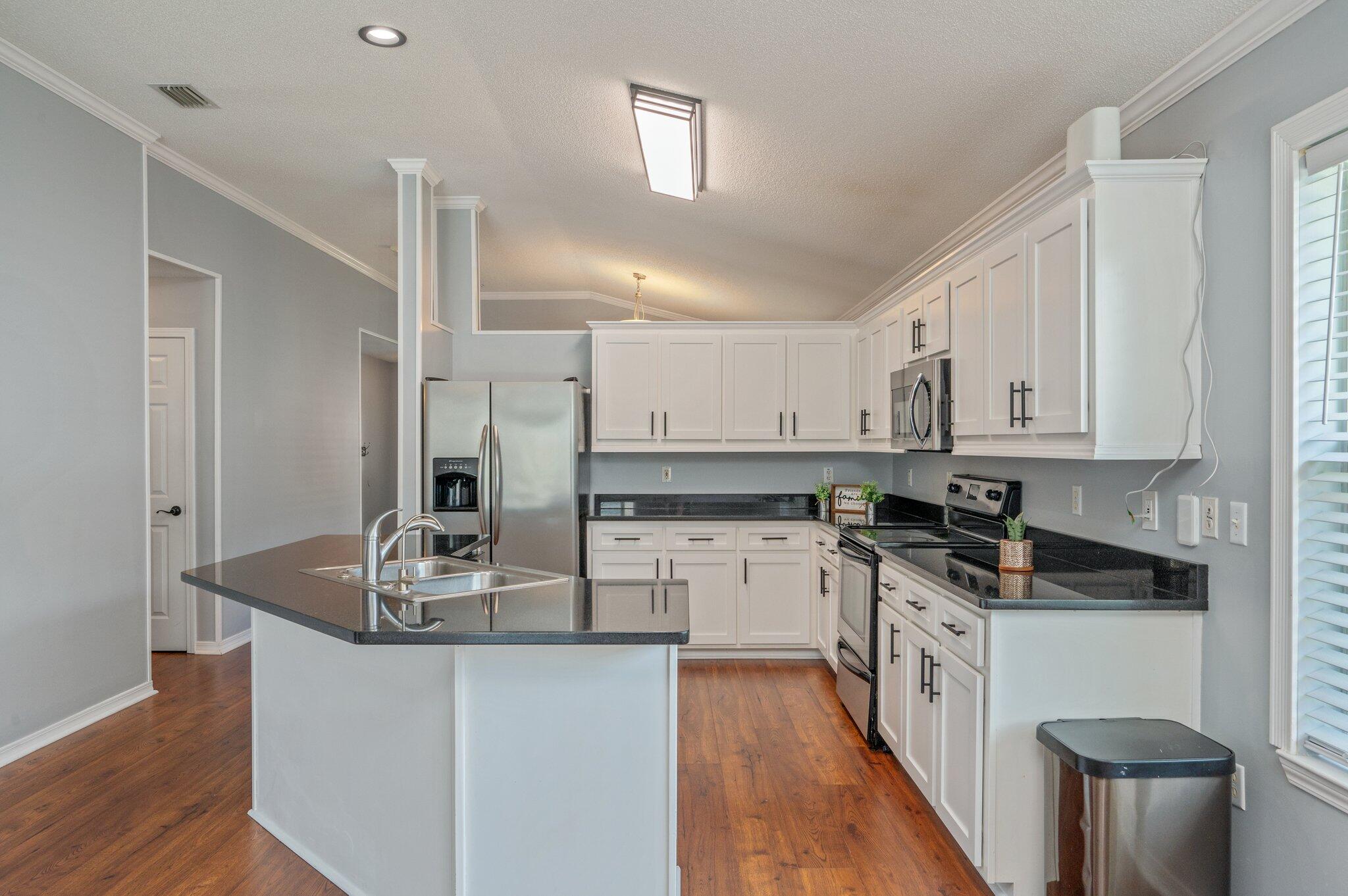 695 Randall Roberts Road Fort Walton Beach, FL 32547 - Photo 12 of 40 a kitchen with stainless steel appliances granite countertop a sink stove and refrigerator
