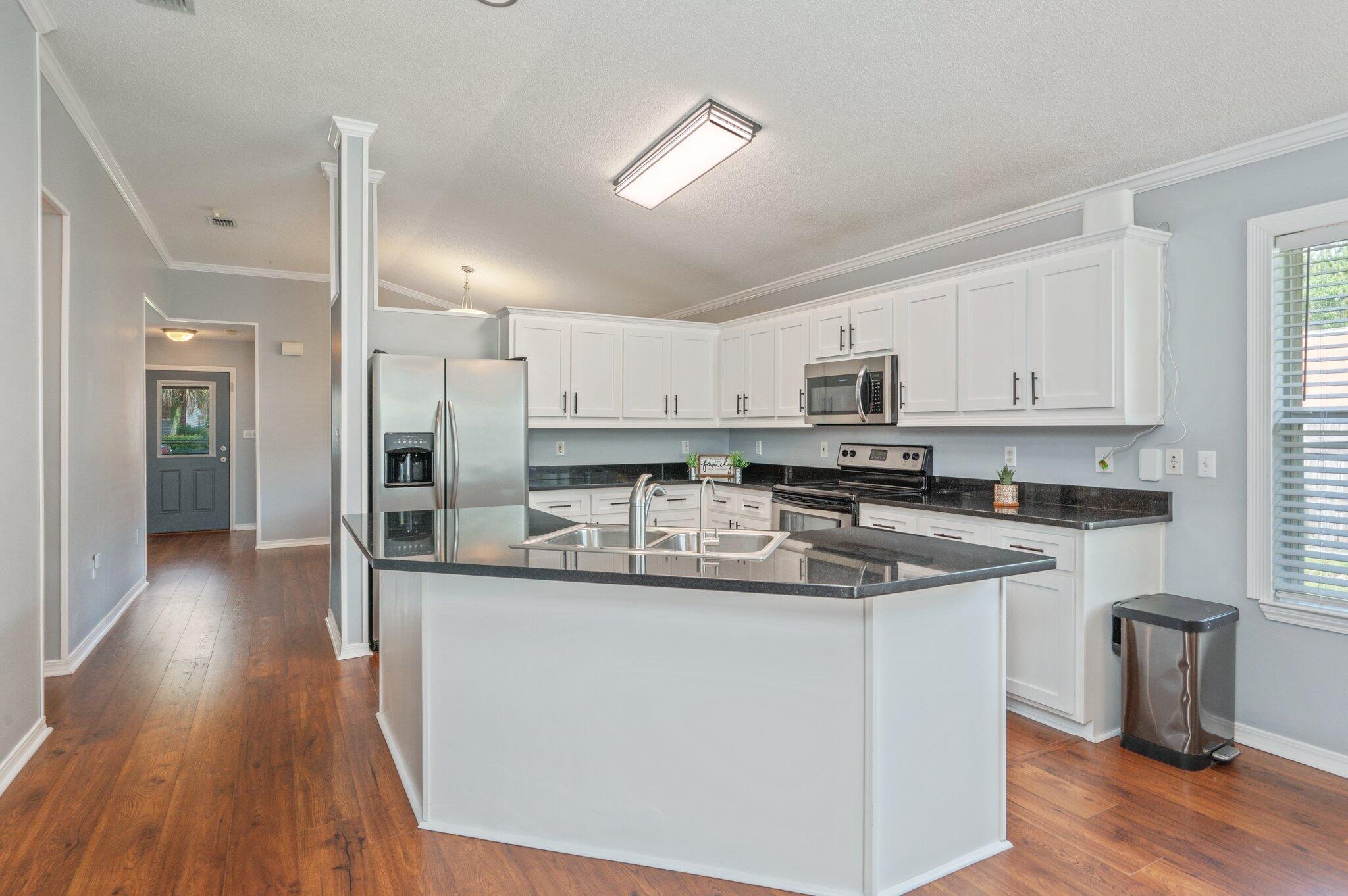 695 Randall Roberts Road Fort Walton Beach, FL 32547 - Photo 13 of 40 a kitchen with stainless steel appliances granite countertop a sink a stove and a refrigerator