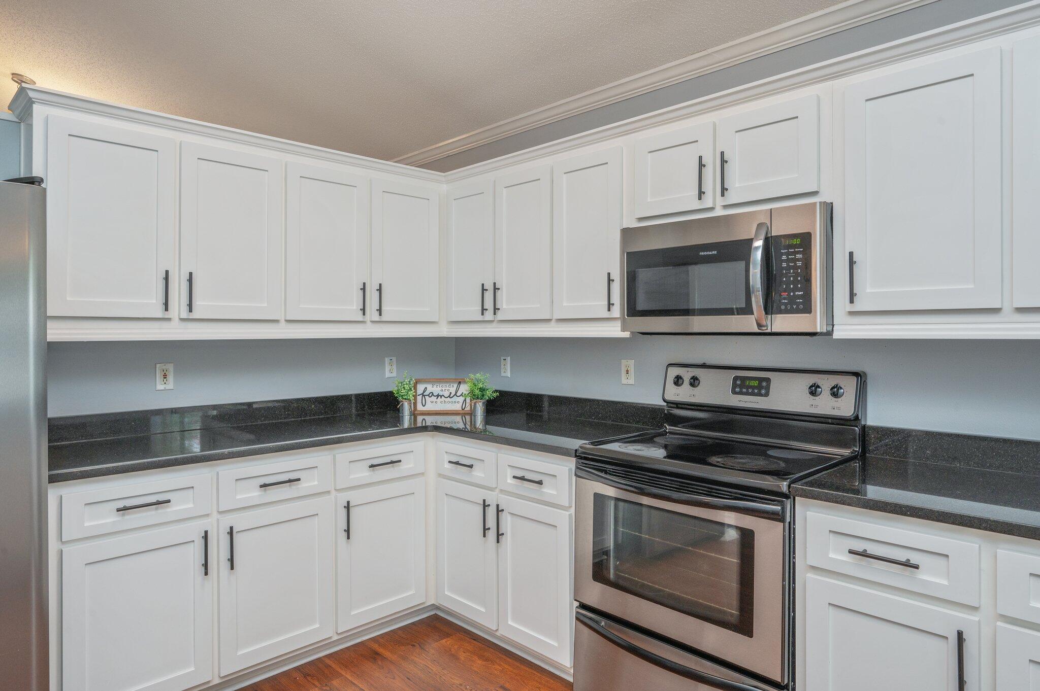 695 Randall Roberts Road Fort Walton Beach, FL 32547 - Photo 14 of 40 a kitchen with white cabinets and appliances