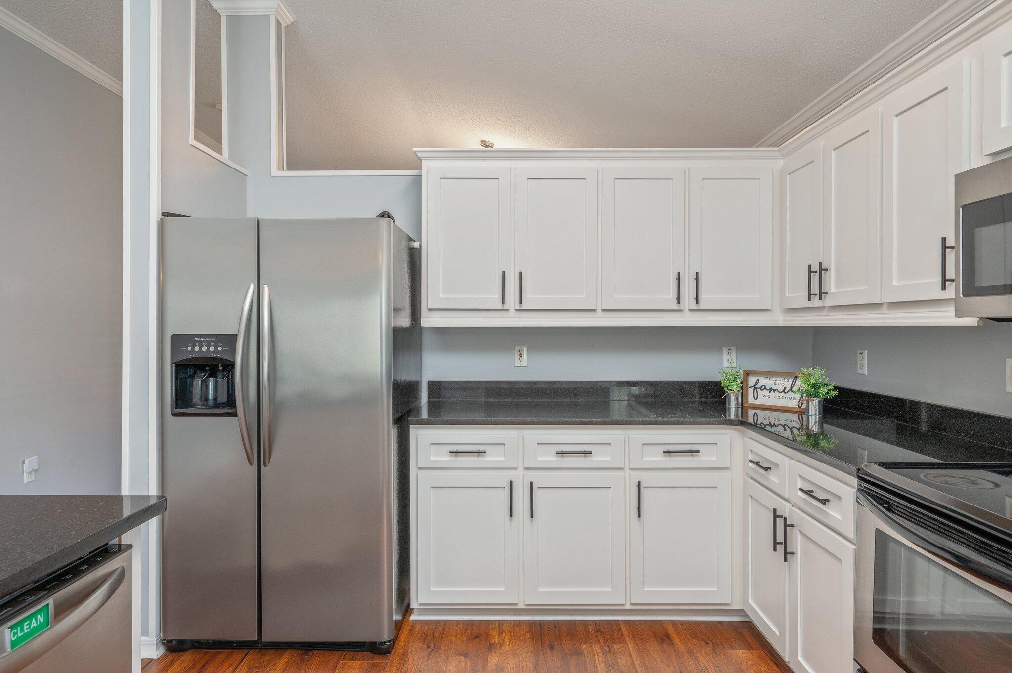 695 Randall Roberts Road Fort Walton Beach, FL 32547 - Photo 16 of 40 a kitchen with white cabinets and refrigerator