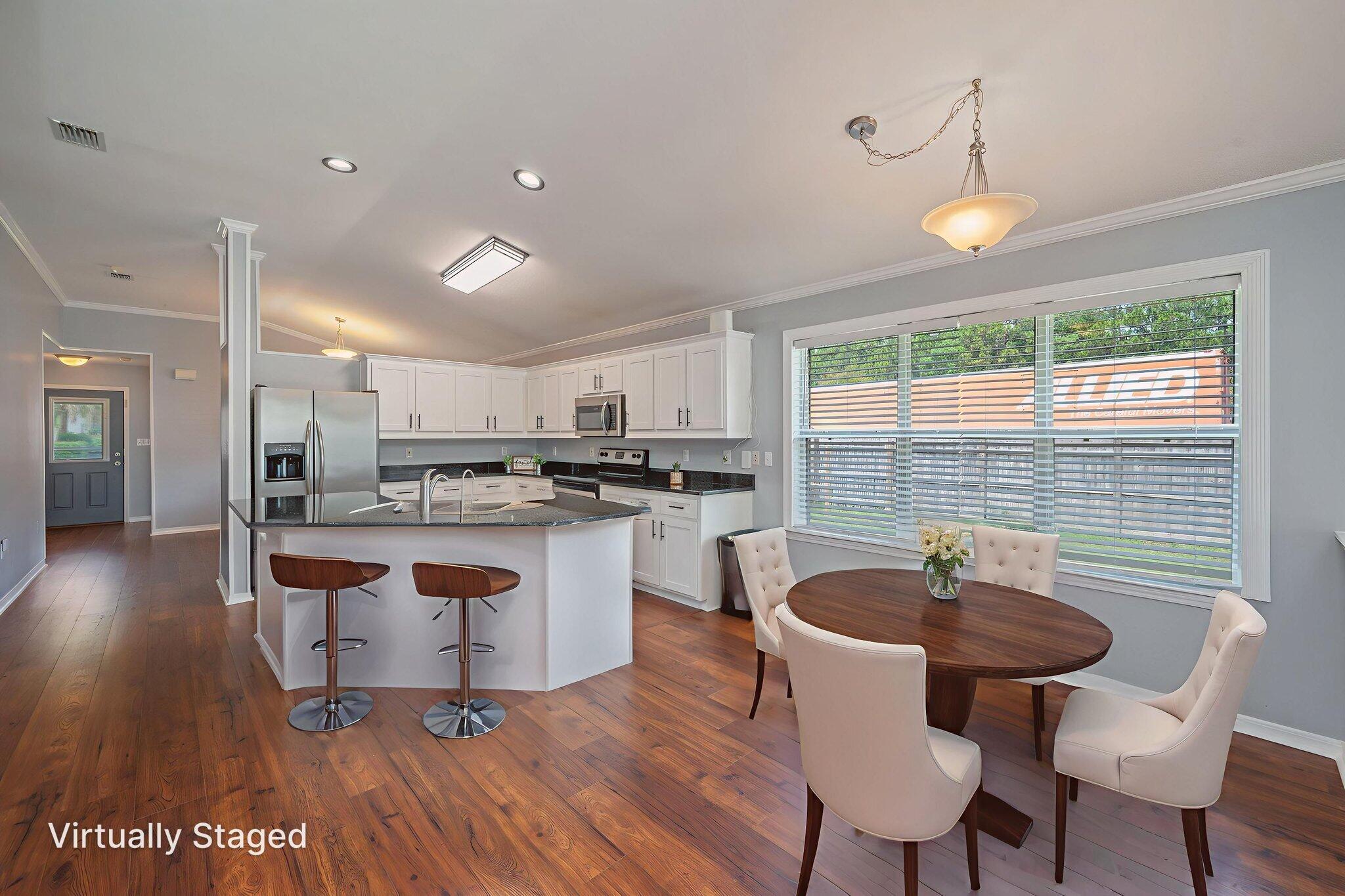 695 Randall Roberts Road Fort Walton Beach, FL 32547 - Photo 17 of 40 a kitchen with a table chairs sink and cabinets