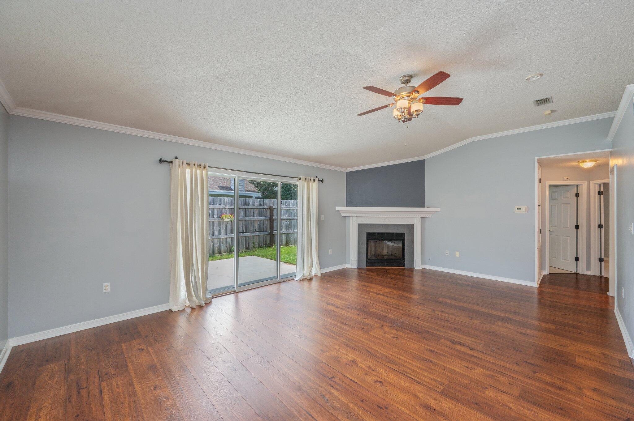 695 Randall Roberts Road Fort Walton Beach, FL 32547 - Photo 20 of 40 a view of an empty room with window and wooden floor