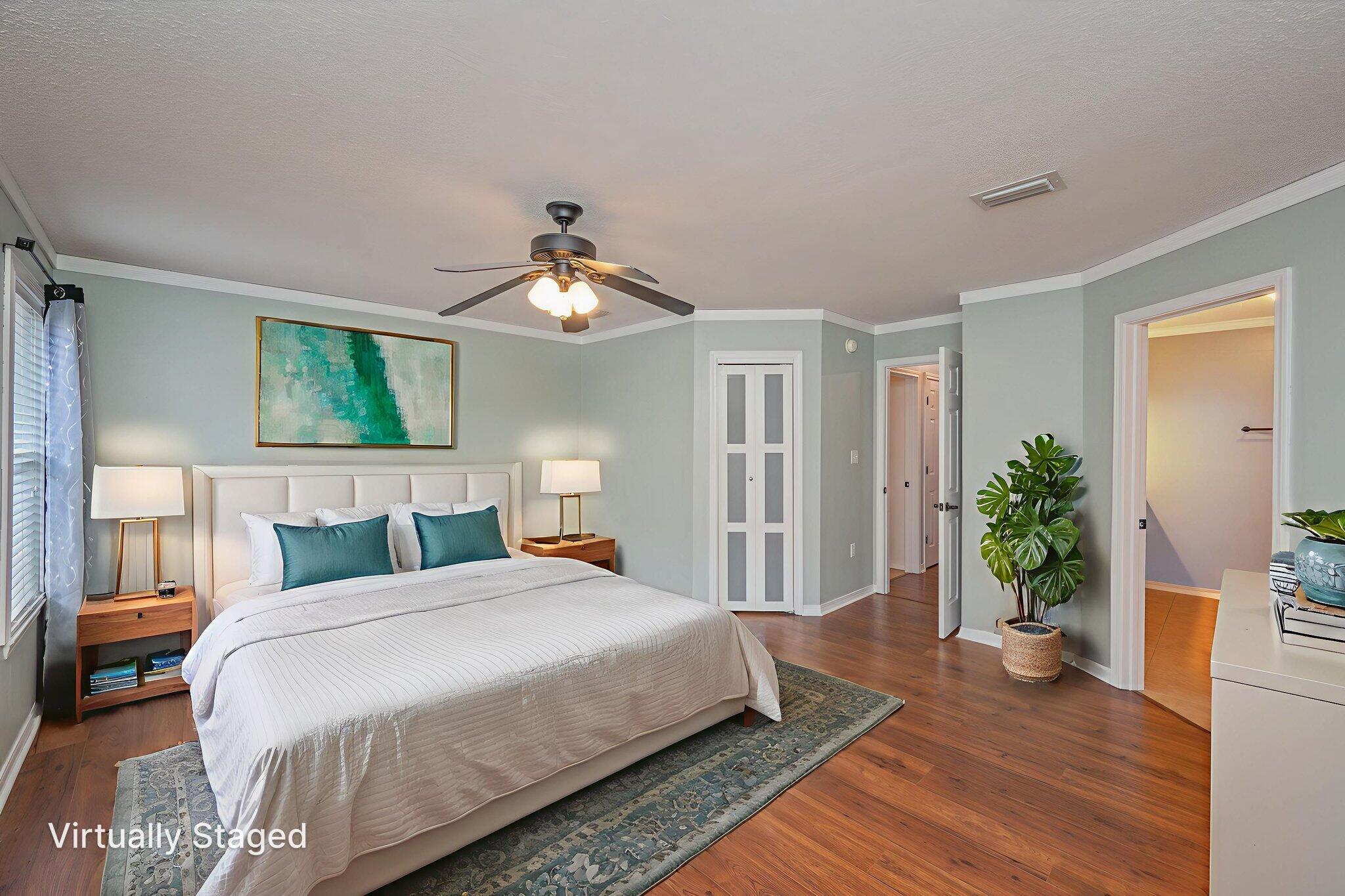 695 Randall Roberts Road Fort Walton Beach, FL 32547 - Photo 22 of 40 a bedroom with a large bed and a wooden floor