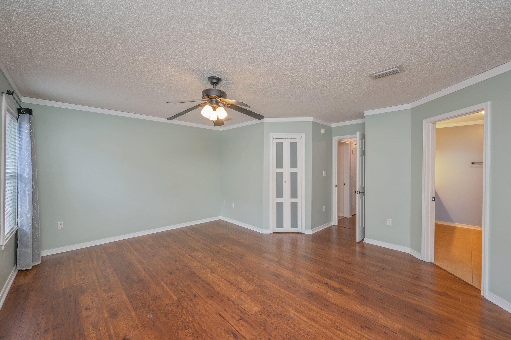695 Randall Roberts Road Fort Walton Beach, FL 32547 - Photo 23 of 40 wooden floor in an empty room with a window