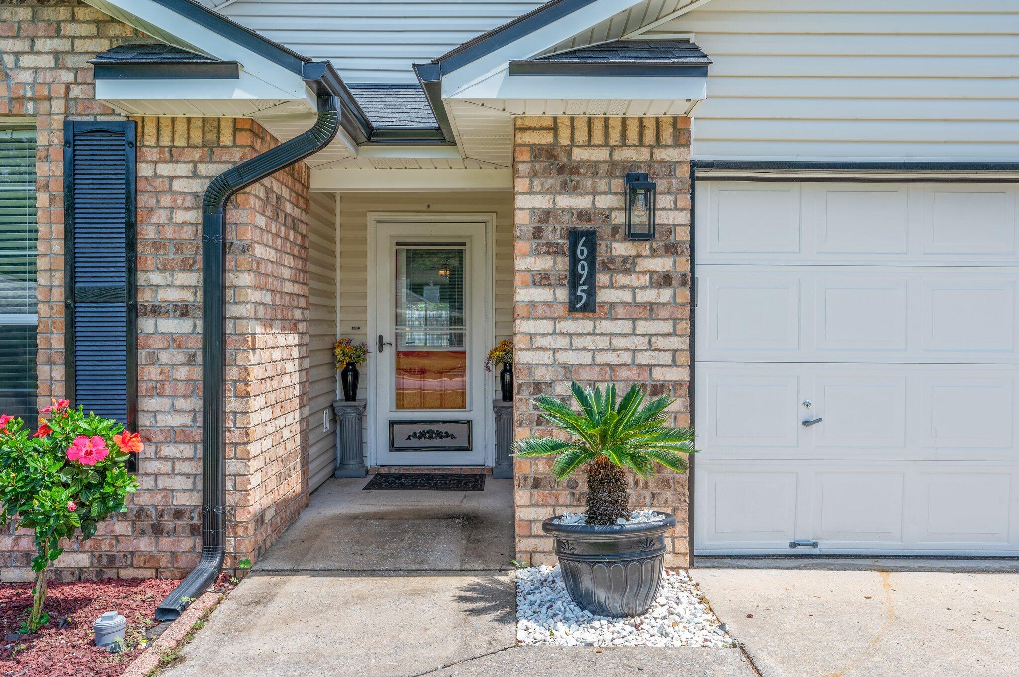 695 Randall Roberts Road Fort Walton Beach, FL 32547 - Photo 3 of 40 a potted plant sitting in front of a house